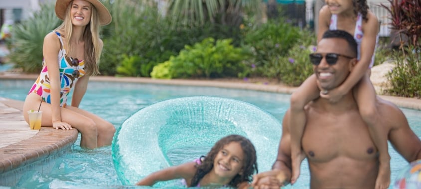 Family playing in pool